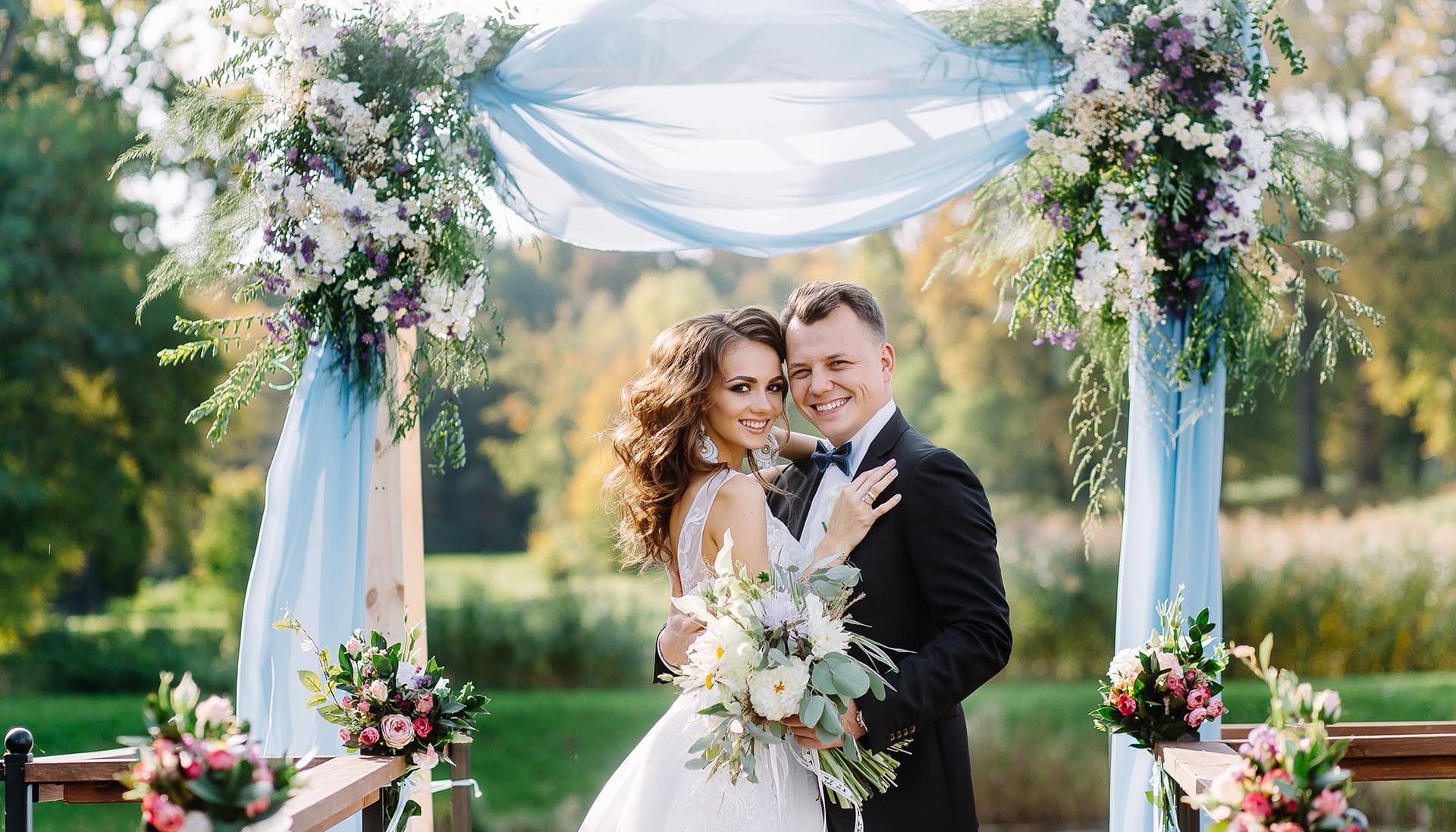 Newlyweds embracing each other at the alter